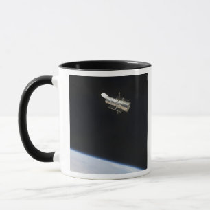 The Hubble Space Telescope in orbit above Earth 2 Mug