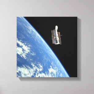 The Hubble Space Telescope with a blue earth Canvas Print