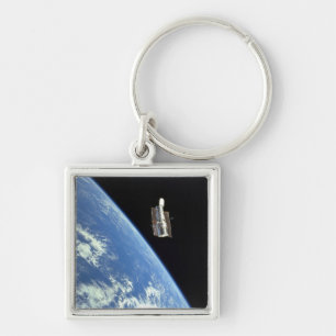 The Hubble Space Telescope with a blue earth Key Ring