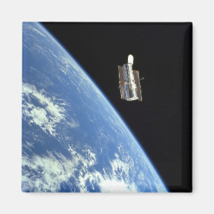 The Hubble Space Telescope with a blue earth Magnet