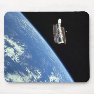 The Hubble Space Telescope with a blue earth Mouse Mat