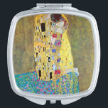 The Kiss by Gustav Klimt, Vintage Art Nouveau Travel Mirror<br><div class="desc">The Kiss (Der Kuss) (1907/08) by Gustav Klimt is probably his most famous work. Klimt began work on it in 1907 and it is the highpoint of his so-called 'Golden Period'. The Kiss is a vintage Victorian Era Symbolism fine art love and romance painting featuring a romantic couple in various...</div>