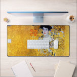 The Lady in Gold, Gustav Klimt Desk Mat<br><div class="desc">Gustav Klimt (July 14, 1862 – February 6, 1918) was an Austrian symbolist painter and one of the most prominent members of the Vienna Secession movement. Klimt is noted for his paintings, murals, sketches, and other objets d'art. In addition to his figurative works, which include allegories and portraits, he painted...</div>