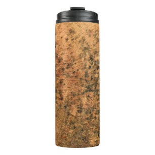 The mold that grows on the brown wood surface is d thermal tumbler