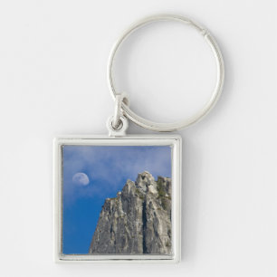 The moon rises and shines through the clouds key ring