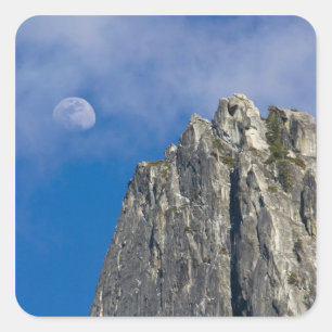 The moon rises and shines through the clouds square sticker