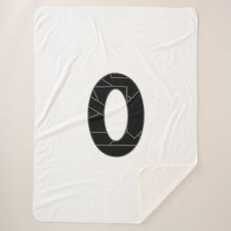 The number zero (0) in black sherpa blanket
