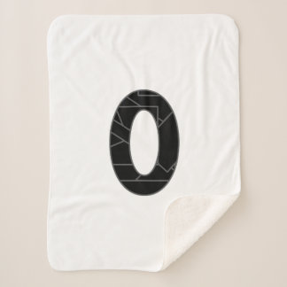 The number zero (0) in black sherpa blanket
