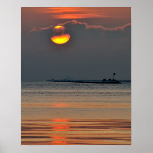The sun emerges through an off-shore fog bank poster