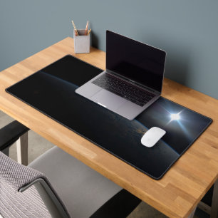 The Sun Setting Over Earth's Horizon. Desk Mat