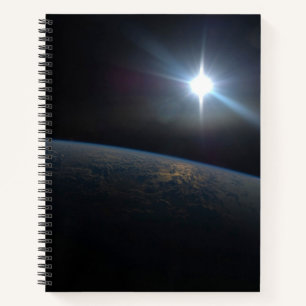The Sun Setting Over Earth's Horizon. Notebook