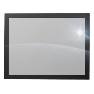 The Sun Setting Over Earth's Horizon. Notepad