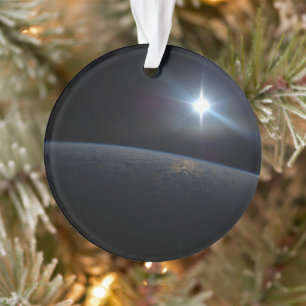 The Sun Setting Over Earth's Horizon. Ornament