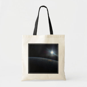 The Sun Setting Over Earth's Horizon. Tote Bag