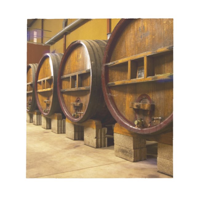 The wine cellar winery with big old wooden casks notepad (Front)
