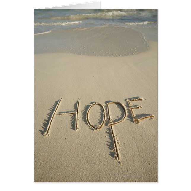 The word 'Hope' sand written on the beach with (Front)