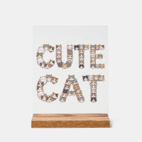 The words "CUTE CAT" are made using cat faces