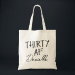 THIRTY AF Personalised Funny 30th Birthday Tote Bag<br><div class="desc">This personalised “THIRTY AF” tote bag is the ultimate 30th birthday accessory — bold, fun, and fabulously functional. Featuring a custom name in elegant script beneath the playful slogan, it’s perfect for brunches, gifting, errands, or that post-party coffee run. Made for birthdays with attitude, this bag is as stylish as...</div>