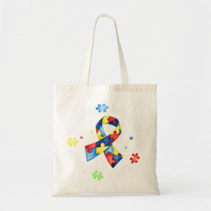 This tee with autism puzzle slogan "Teach Accept U Tote Bag