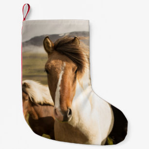 THREE ASSORTED-COLOR HORSES RUNNING AWAY FROM A MO SMALL CHRISTMAS STOCKING