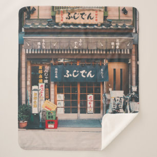 THREE BICYCLES PARKED IN FRONT OF BUILDING SHERPA BLANKET