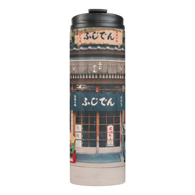 THREE BICYCLES PARKED IN FRONT OF BUILDING THERMAL TUMBLER (Front)