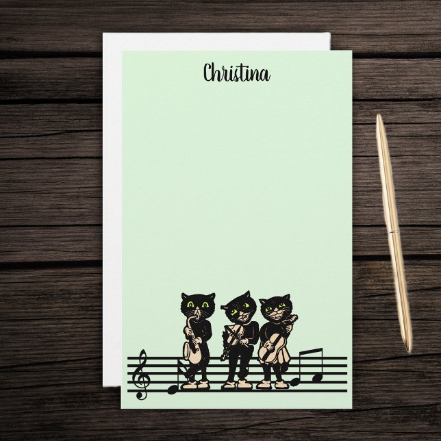 Three Black Cat Musicians Music Instruments Green Stationery (Three black cat musicians playing instruments on bar of music notes on green stationery paper pad.)