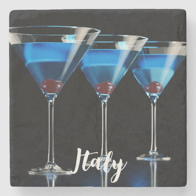 Three blue cocktails with cherry on black stone coaster (Front)