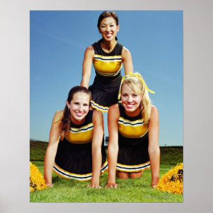 Three cheerleaders forming human pyramid on poster