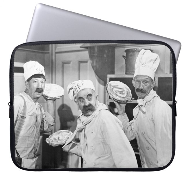 Three chefs holding pies for a fight in the kitche laptop sleeve (Front)