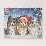 Three Cute Christmas Shelties in the Snow Jigsaw Puzzle<br><div class="desc">This adorable puzzle features a watercolor painting of three shelties sitting in the snow. The sheltie in the middle is wearing Santa's hat</div>