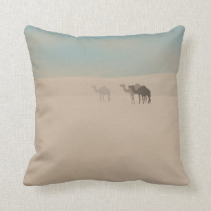 Three dromedary camels walking in Sahara desert Cushion