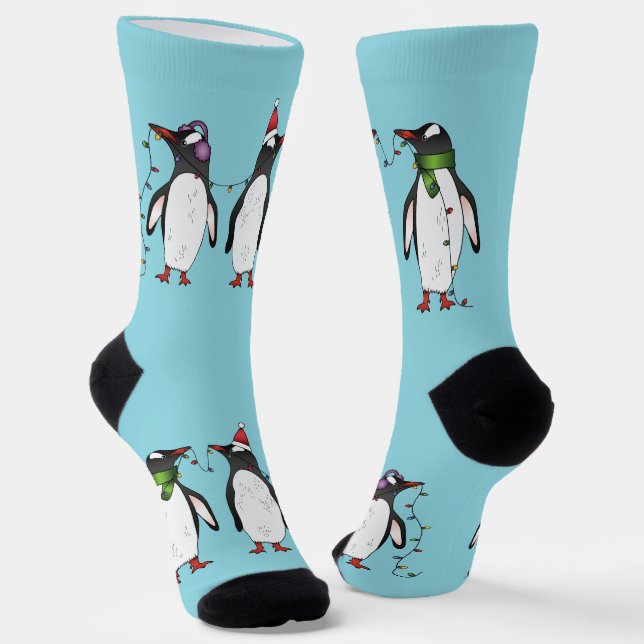 Three Festive Christmas Penguins On Light Blue Socks (Angled)