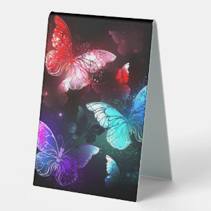 Three Glowing Butterflies on night background