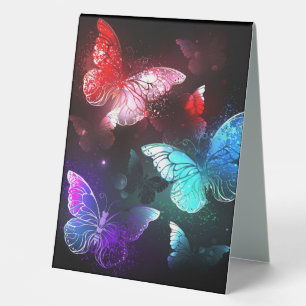 Three Glowing Butterflies on night background