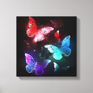 Three Glowing Butterflies on night background Canvas Print