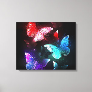 Three Glowing Butterflies on night background Canvas Print