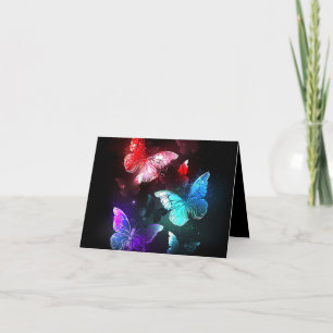 Three Glowing Butterflies on night background Card