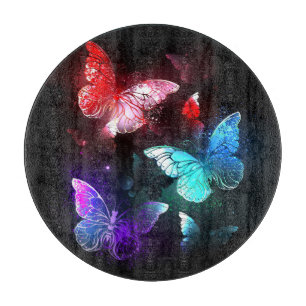 Three Glowing Butterflies on night background Cutting Board
