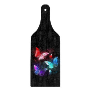 Three Glowing Butterflies on night background Cutting Board