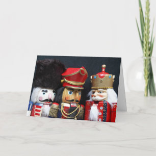 Three nutcrackers on black Christmas card