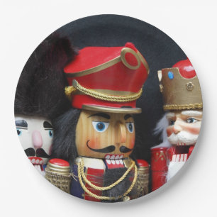 Three nutcrackers on dark background paper plate