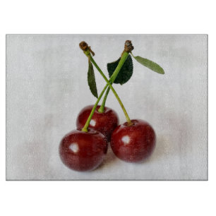 three sour cherries cutting board