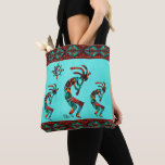 Three Southwest Kokopelli And Sun Tote Bag<br><div class="desc">This is a Unique "One of a Kind" Southwest Kokopelli and Sun Tote Bag!  It Features Three Southwest Kokopelli Playing the Flute and Dancing Under the Sun on a Turquoise Background... Surrounded by Southwest Borders in Turquoise,  Orange and Black!

Original Art Design By Artist Kerry Miller.</div>