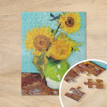 Three Sunflowers | Vincent van Gogh Jigsaw Puzzle<br><div class="desc">Three Sunflowers (1888) by Vincent van Gogh is a vibrant still life that showcases the artist’s signature thick brushstrokes and bold use of colour. The painting features three sunflowers in a simple vase, their golden petals contrasting against the aqua blue background. Van Gogh's vivid yellow palette brings energy and life...</div>