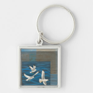 Three White Seagulls Flying Over the Water Key Ring