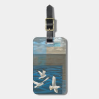 Three White Seagulls Flying Over the Water