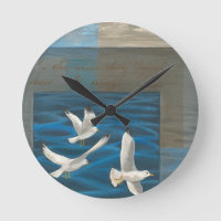 Three White Seagulls Flying Over the Water