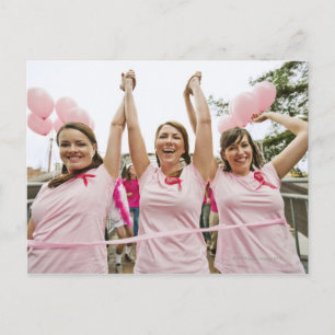 Three young women dressed in pink run in postcard