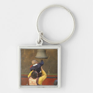 Tibetan Buddhist monk lifting a boy to ring a Key Ring
